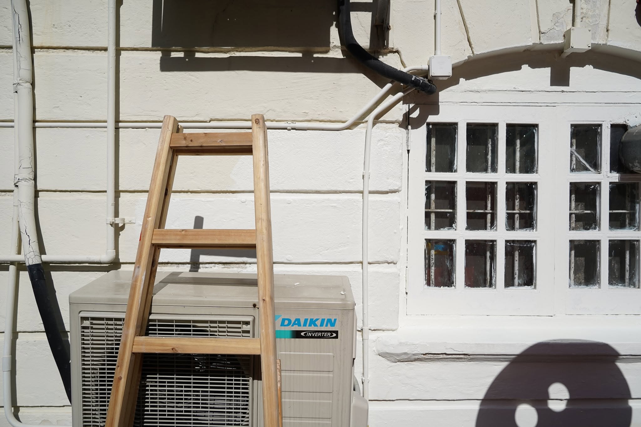 A volunteer painting the exterior of a building